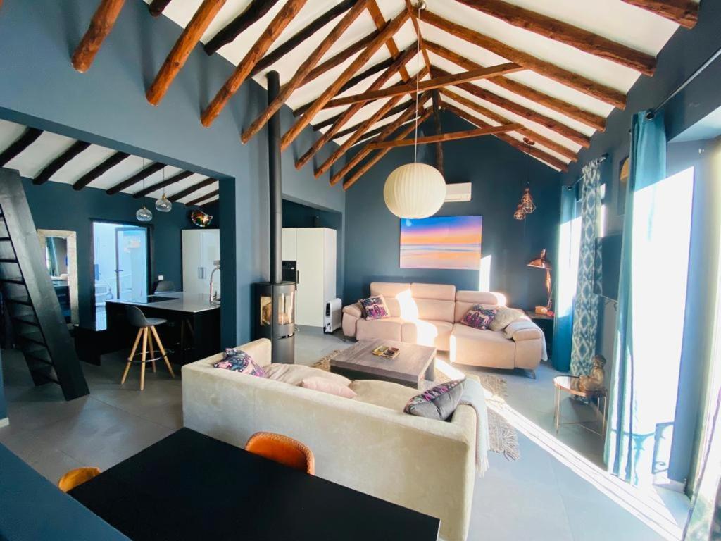 Wide view of the living room, with the kitchen at the far end