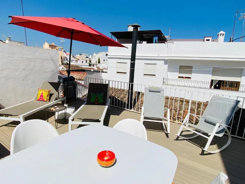 Rooftop solarium with loungers, looking over the town roofs