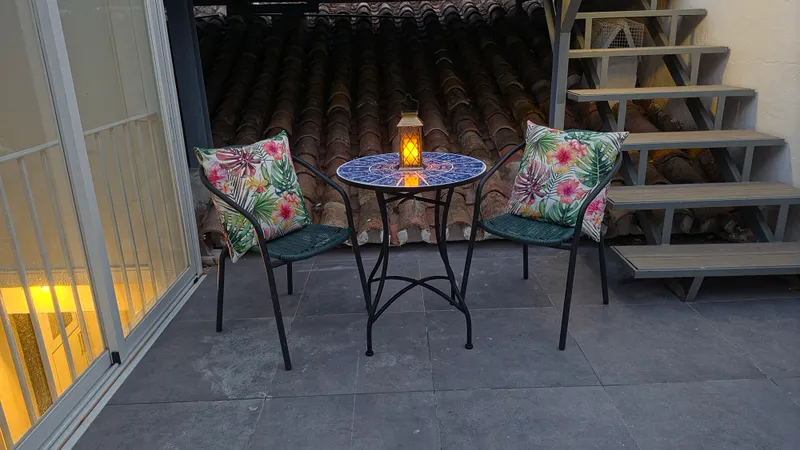 Small terrace table set with a lantern at night