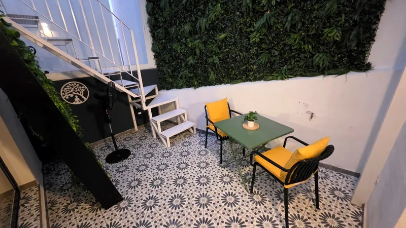 Covered patio stairs and yellow chairs at dusk