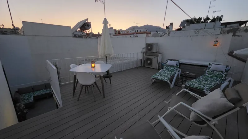 Rooftop at dusk, with the mountains beyond the town